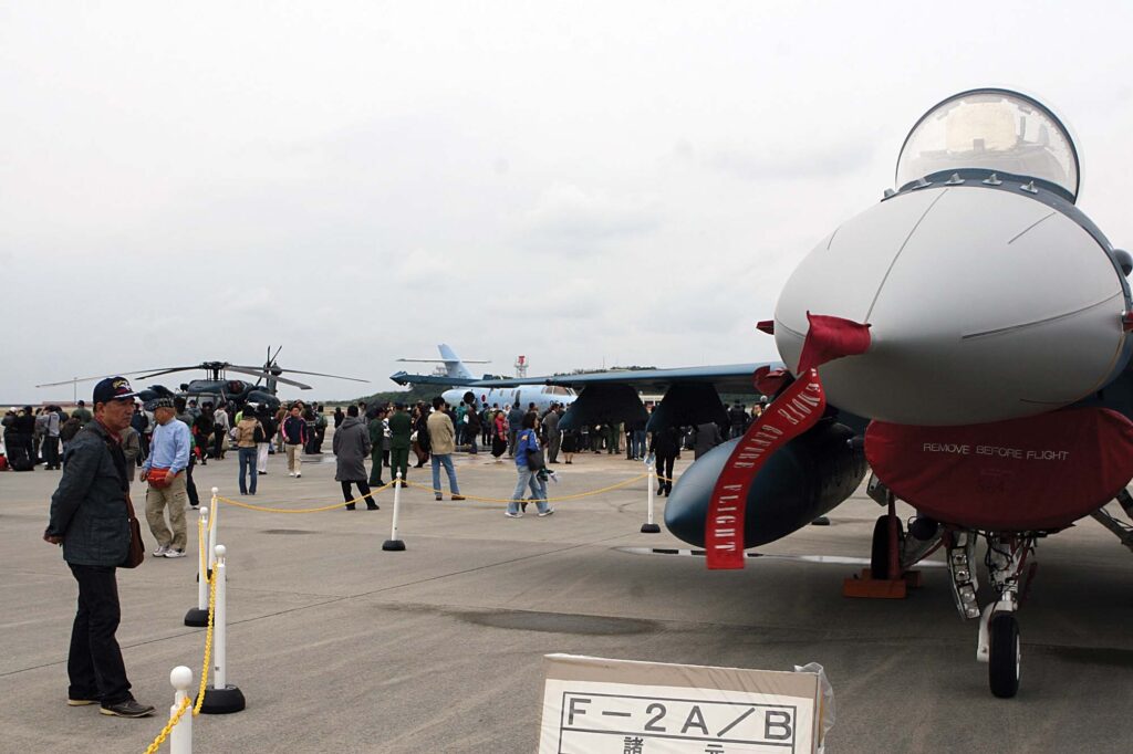 A local veteran admires a Mitsubishi F-2 fighter on display at the Air Fiesta 2011 on Naha Air Base Dec. 11. Local community members and guests had a chance to take a look inside the static displays and see what it is like piloting the aircraft.